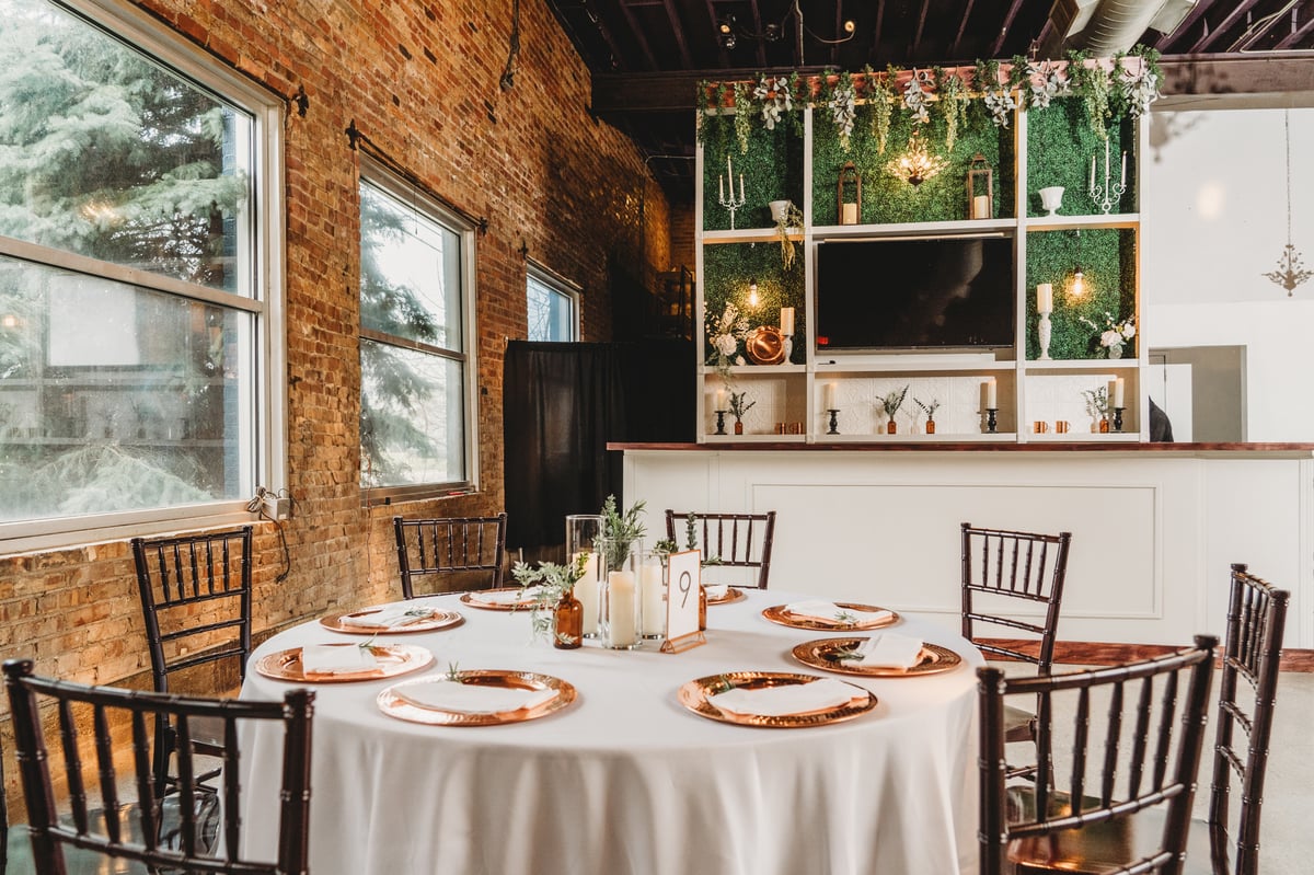 Dining table set with bar in background at Copper Moon